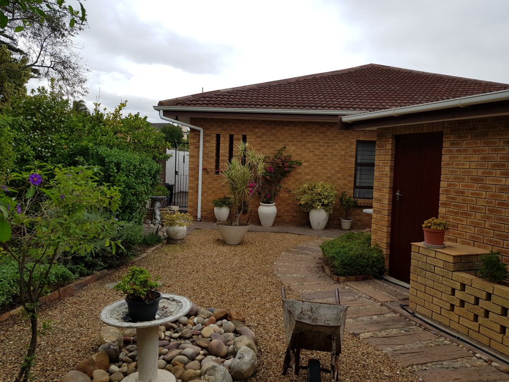 Back Garden to Garden to Shed on right and Kitchen in Front